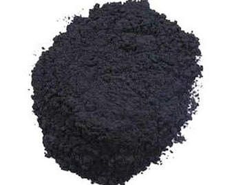 May include: A close-up of a pile of black powder. The powder is fine and has a slightly grainy texture.