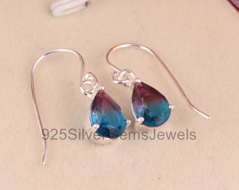 May include: A pair of silver teardrop earrings with blue and purple gradient gemstones. The earrings have a simple design and are perfect for everyday wear.