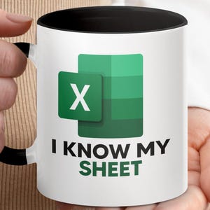 May include: White ceramic mug with a black interior and handle. The mug features the Microsoft Excel logo in green and white, with the text "I KNOW MY SHEET" in black and green.