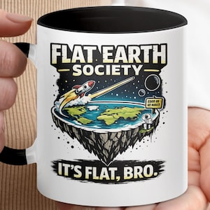 May include: White ceramic mug with a black interior and handle. The mug features a colorful graphic of a flat Earth with a rocket ship, the text "FLAT EARTH SOCIETY" and "IT'S FLAT, BRO."