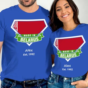 May include: Two people wearing blue t-shirts. Each shirt has a graphic of the Belarus flag and the text "MADE IN BELARUS". The shirts also display the name "Alex" and the year "Est. 1992".