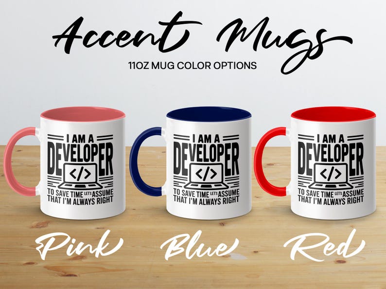 Three 11oz mugs with "I AM A DEVELOPER" text in pink, blue, and red.