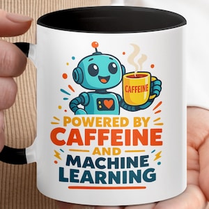 May include: White ceramic mug with a black interior and handle. The mug features a cartoon robot holding a yellow coffee cup with the word "CAFFEINE" on it. Text on the mug reads "POWERED BY CAFFEINE AND MACHINE LEARNING."