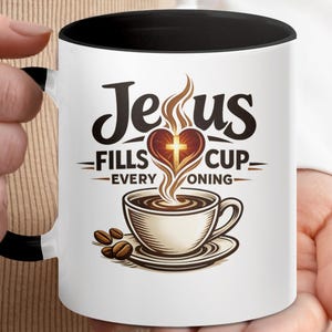 May include: White coffee mug with a black interior and handle. The mug features the text "Jesus Fills Cup Every Morning" with a heart and cross design, and a coffee cup illustration.