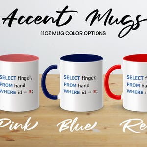Three accent mugs in pink, blue, and red with programming text.