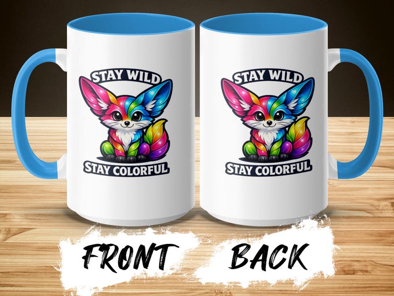 Two white mugs with blue handles, featuring a colorful fox and the text "STAY WILD STAY COLORFUL."