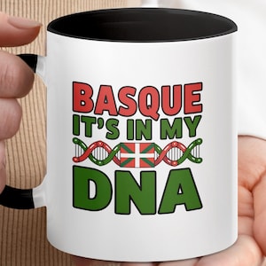 May include: White ceramic mug with a black interior and handle. The mug features the text "BASQUE IT'S IN MY DNA" in red and green, with a DNA strand design and the Basque flag.