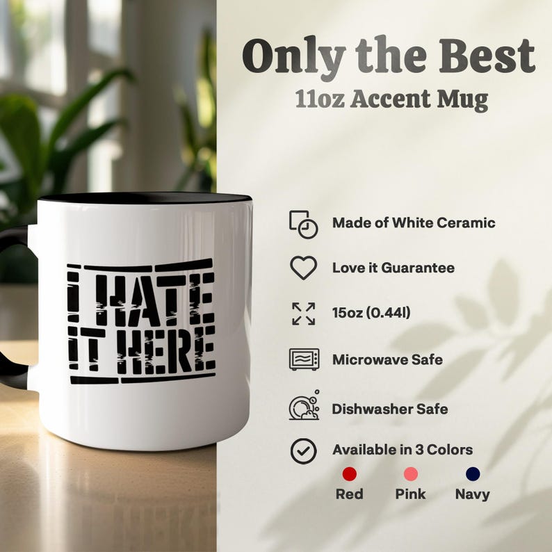 White ceramic accent mug with "I hate it here" text, dishwasher safe.
