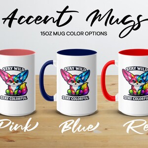 Three colorful fox mugs with "STAY WILD STAY COLORFUL" text, in pink, blue, and red.