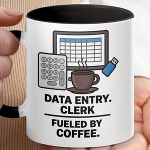 May include: White ceramic mug with a black interior and handle, featuring a design for data entry clerks. The design includes a calculator, computer screen, USB drive, and a coffee cup. Text reads "DATA ENTRY. CLERK. FUELED BY COFFEE."