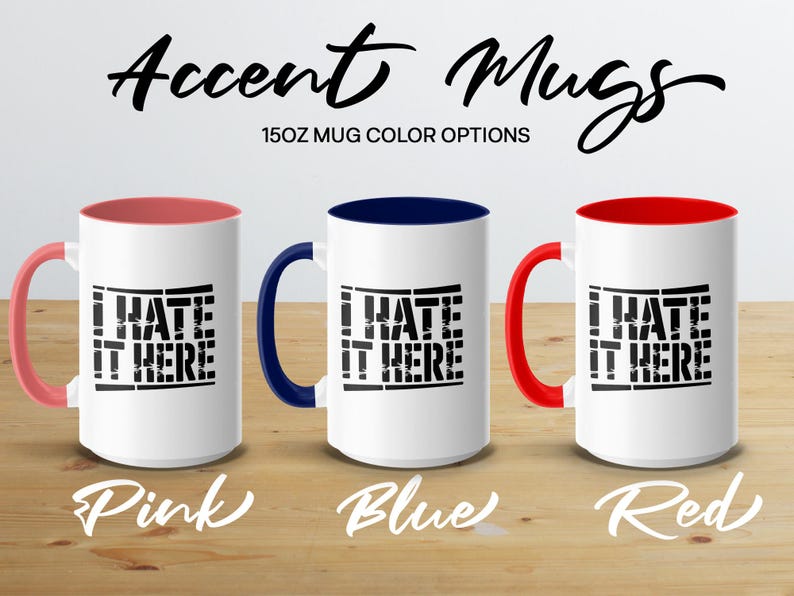 Three white mugs with "I HATE IT HERE" in black, in pink, blue, and red options.