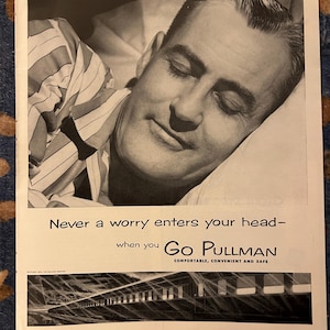 May include: Black and white advertisement featuring a man sleeping peacefully. He is wearing striped pajamas and resting on a pillow. The text reads "Never a worry enters your head- when you Go Pullman. Comfortable, Convenient and Safe."