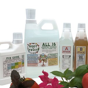 May include: A set of six clear plastic bottles with labels for a plant fertilizer product called "Root Fruit". The bottles are labeled with the names "All 16", "Mix Guide", "A Stock", "B Stock", and "Root Fruit All 16". The bottles are arranged in a row on a white background with a tomato, basil, and pink flowers in front of them.