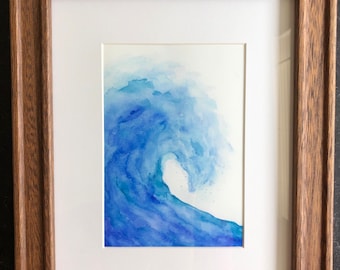 May include: A framed watercolor painting of a blue wave crashing. The wave is painted in shades of blue and white, with a white background.