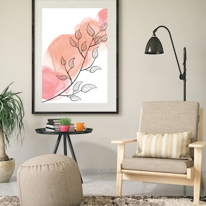 May include: A framed print with a black and white illustration of a branch with leaves on a pink watercolor background.