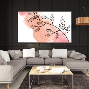 May include: A modern living room with a sectional sofa, a coffee table, and a floor lamp. A large abstract painting with pink and white watercolor and black line art of a branch with leaves hangs on the wall.