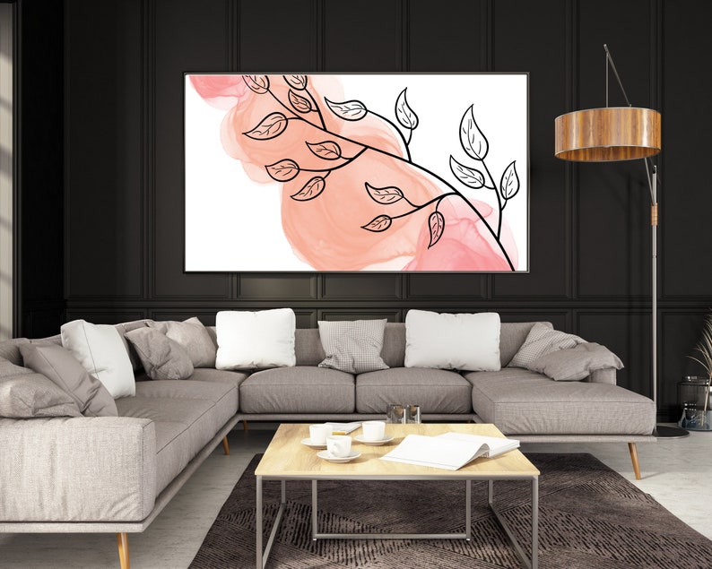 May include: A modern living room with a sectional sofa, a coffee table, and a floor lamp. A large abstract painting with pink and white watercolor and black line art of a branch with leaves hangs on the wall.