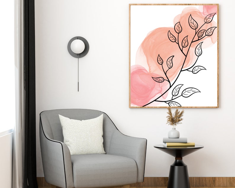 May include: A framed abstract art print with a black line drawing of a branch with leaves on a white background. The background has pink watercolor washes.