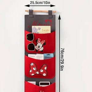 May include: Red and gray wall organizer with three pockets featuring a Mickey Mouse character and a red bow. The organizer measures 29 inches tall and 10 inches wide.