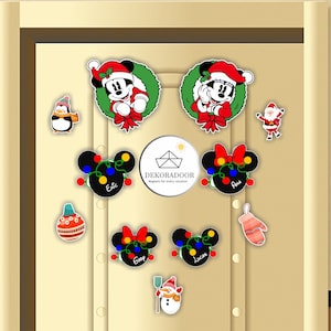 May include: A set of 10 Christmas-themed magnets featuring Mickey Mouse and Minnie Mouse, a penguin, Santa Claus, a snowman, a Christmas ornament, and a mitten. The magnets are decorated with lights, bows, and wreaths. The magnets are labeled with the names Eric, Ava, Gray, and Lucas.