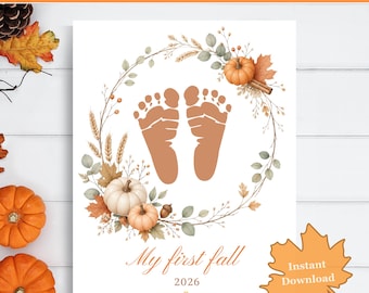 May include: A printable wall art design featuring a pair of brown baby footprints centered within a wreath of autumn leaves, wheat, and pumpkins. The text reads My first fall 2026. The design is set against a white background with fall decor.