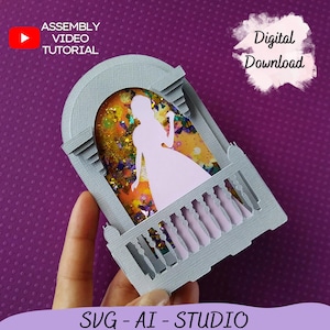 May include: A gray papercraft of a balcony with a silhouette of a princess in a white dress. The balcony has a pink railing and a window with a glittery background. The text "Digital Download" is in the upper right corner of the image. The text "SVG - AI - STUDIO" is at the bottom of the image.