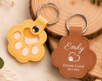 May include: Two paw-shaped keychains with metal rings. One is yellow with a cutout paw design, and the other is brown with the engraved text Emily, a heart with a paw print, and the words Forever Loved 2012-2025.