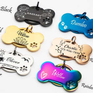 May include: A set of ten personalized dog bone-shaped tags in various colors, including black, gold, silver, blue, rose gold, and rainbow. Each tag features a different design and engraving, such as a palm tree, flowers, a rocket ship, and paw prints.