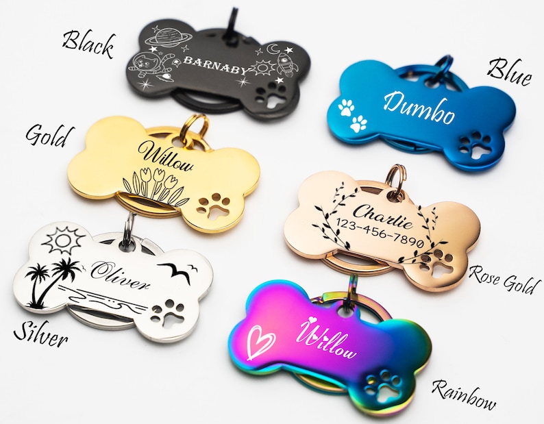 May include: A set of ten personalized dog bone-shaped tags in various colors, including black, gold, silver, blue, rose gold, and rainbow. Each tag features a different design and engraving, such as a palm tree, flowers, a rocket ship, and paw prints.