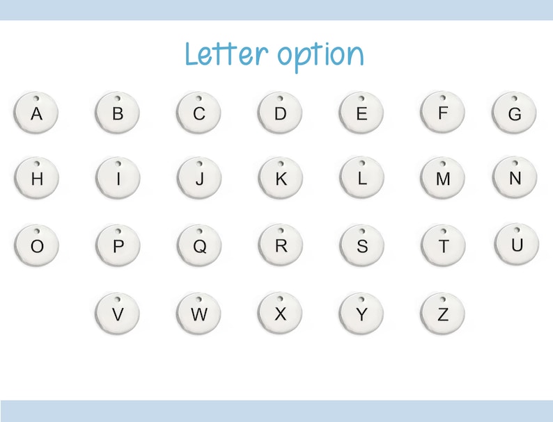 May include: A set of 26 white round metal tags with black letters, each letter of the alphabet is represented.