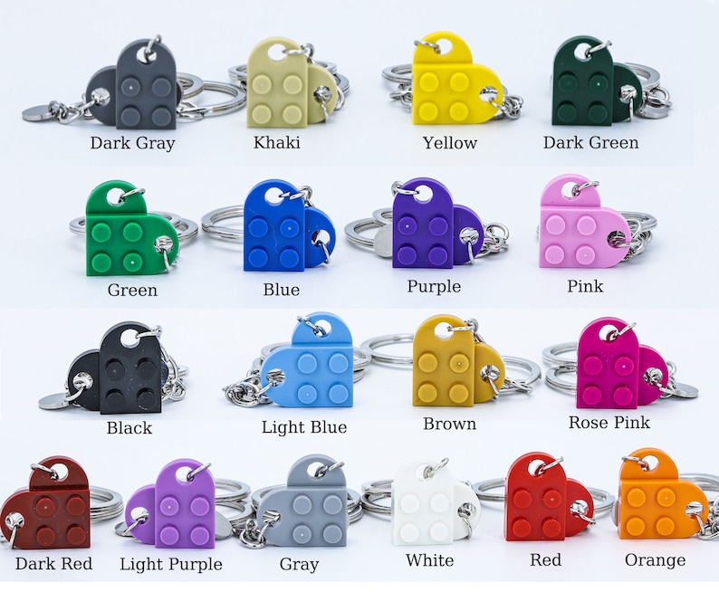 May include: A set of 16 heart-shaped keychains made from LEGO bricks in various colors, including dark gray, khaki, yellow, dark green, green, blue, purple, pink, black, light blue, brown, rose pink, dark red, light purple, gray, white, red, and orange.