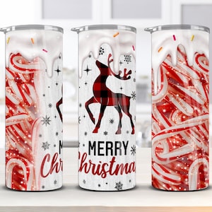 May include: Three white tumblers with a Christmas theme. The tumblers feature a red and white candy cane design, a red and black plaid reindeer, and the words "Merry Christmas".
