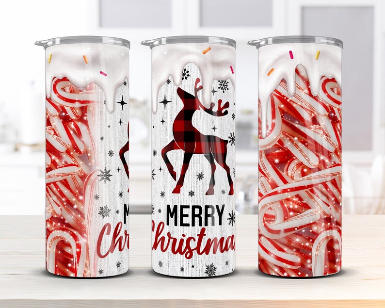 May include: Three white tumblers with a Christmas theme. The tumblers feature a red and white candy cane design, a red and black plaid reindeer, and the words "Merry Christmas".