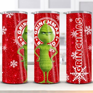 May include: Three stainless steel tumblers with a red glitter background and white snowflakes. The center tumbler features a green Grinch character with the text "Grinchmas" in a red circle. The left and right tumblers have the text "Grinchmas" in white.