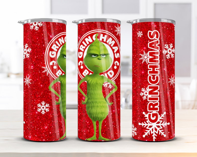 May include: Three stainless steel tumblers with a red glitter background and white snowflakes. The center tumbler features a green Grinch character with the text "Grinchmas" in a red circle. The left and right tumblers have the text "Grinchmas" in white.