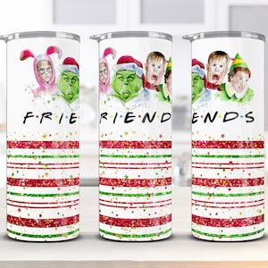 May include: Set of three white tumblers with a Christmas-themed design. Each tumbler features a different character from the movie "Elf" and the word "FRIENDS" is spelled out across the three tumblers. The tumblers have red and green stripes with gold glitter.