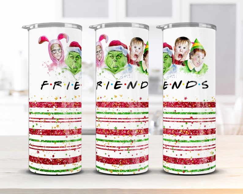 May include: Set of three white tumblers with a Christmas-themed design. Each tumbler features a different character from the movie "Elf" and the word "FRIENDS" is spelled out across the three tumblers. The tumblers have red and green stripes with gold glitter.