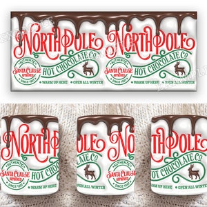 K&ouml;nnte beinhalten: Wei&szlig;e Keramiktasse mit einem roten und gr&uuml;nen Design, auf dem "North Pole Hot Chocolate Co." steht, mit einem tropfenden Schokoladeneffekt. Die Tasse hat ein von Santa Claus zugelassenes Logo und den Text "W&auml;rmen Sie sich hier auf. Ganzj&auml;hrig ge&ouml;ffnet."