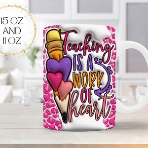 May include: White ceramic mug with a pencil and heart design. The mug features the text "Teaching is a work of heart" in pink, purple, and orange. The background has a pink leopard print pattern. The mug is available in 15 oz and 11 oz sizes.