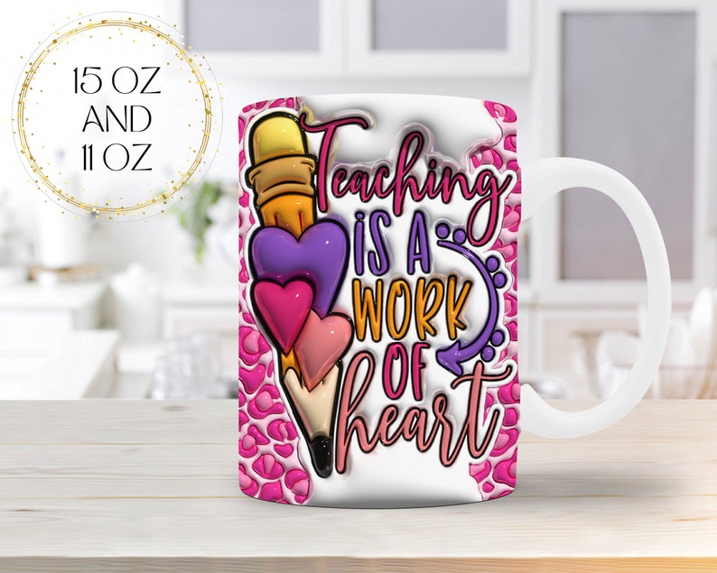 May include: White ceramic mug with a pencil and heart design. The mug features the text "Teaching is a work of heart" in pink, purple, and orange. The background has a pink leopard print pattern. The mug is available in 15 oz and 11 oz sizes.