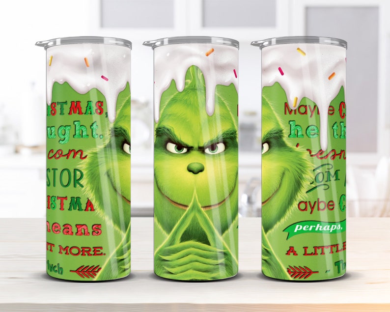May include: A green Grinch character with a white frosting design on a stainless steel tumbler. The tumbler has text that reads "Maybe Christmas...doesn't come from a store. Maybe Christmas...perhaps...means a little bit more."
