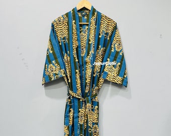 May include: A long, blue and green patterned robe with a tiger print design. The robe is hanging on a wooden hanger. The robe has a matching belt. The text "Jaipurcloth" is visible on the robe.