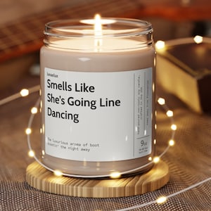 May include: A brown glass candle jar with a white label that reads "Smells Like She's Going Line Dancing". The luxurious aroma of boot scootin' the night away. Hand-poured non-toxic soy candle, crafted in the USA. 9 oz.