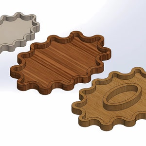 May include: Three wooden trays with wavy edges. The largest tray is plain, the middle tray has a wood grain pattern, and the smallest tray has a smaller oval cutout in the center.