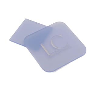 May include: Two pale blue square coasters with rounded corners. One coaster is behind the other. The front coaster has the letters "LC" and the words "LYNNE REID CERAMICS" etched into the surface.