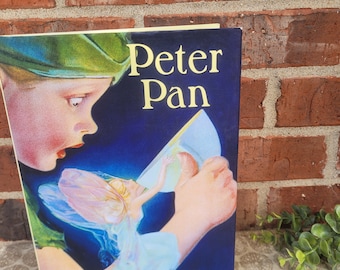 Vintage copy of Peter Pan by Sir J. M. Barrie-beautifully illustrated classic- hardbound book with dust jacket-perfect gift or nursery decor