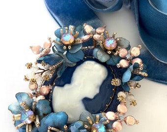 Brooch and Pendant two in one antique style jewelry with an antique Lemoge cabochon depicting a lady surrounded by blue silk flowers.