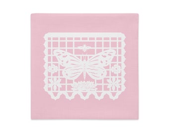 Butterfly decorative pillow sham 18"x18" in baby pink with white papel picado from the book A Is For Alpaca And Amigos © by Lisa Osterman
