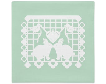 Bunny Rabbit decorative pillow sham 22"x22" in green with white papel picado from the book A Is For Alpaca And Amigos © by Lisa Osterman