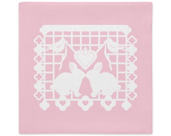 Bunny Rabbit pillow sham 22"x22" in baby pink with white papel picado from the book A Is For Alpaca And Amigos © by Lisa Osterman